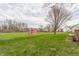 Large backyard with well-maintained grass and a red shed at 11124 Deer Valley Dr, Indianapolis, IN 46229