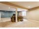 Spacious carpeted basement with structural pillars, neutral walls, and comfortable seating area at 11124 Deer Valley Dr, Indianapolis, IN 46229