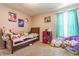 Cozy bedroom with plush decor featuring soft carpet, a window for natural light, and lots of cute stuffed animals at 11124 Deer Valley Dr, Indianapolis, IN 46229
