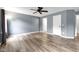 Bright and spacious bedroom with hardwood floors, ceiling fan, neutral gray paint, and a double door closet at 11124 Deer Valley Dr, Indianapolis, IN 46229