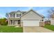 Charming two-story home with a well-maintained lawn, gray siding, and a spacious two-car garage at 11124 Deer Valley Dr, Indianapolis, IN 46229