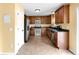 Well-equipped kitchen with wood cabinetry, stainless steel appliances, tile flooring and yellow walls at 11124 Deer Valley Dr, Indianapolis, IN 46229