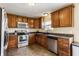 Cozy kitchen with wood cabinets, modern appliances, and tile flooring at 11124 Deer Valley Dr, Indianapolis, IN 46229