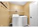 Laundry room complete with washer, dryer, wire shelving, and coat hooks at 11124 Deer Valley Dr, Indianapolis, IN 46229
