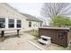 Exterior shot of backyard featuring hot tub, patio, and well-kept yard at 1163 Randall Way, Brownsburg, IN 46112