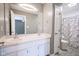 Bathroom with double sinks, large mirror, and toilet with a marbled shower at 1163 Randall Way, Brownsburg, IN 46112