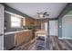 Kitchen with wood cabinets, stainless steel appliances, a kitchen island and wood flooring at 1163 Randall Way, Brownsburg, IN 46112