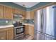 Well-lit kitchen features wooden cabinets, stainless steel appliances and plenty of counter space at 1163 Randall Way, Brownsburg, IN 46112