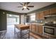 Charming kitchen with wood cabinets, stainless steel appliances, an island and an adjoining sunroom at 1163 Randall Way, Brownsburg, IN 46112