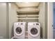 Functional laundry room equipped with modern washer and dryer and storage shelving at 1163 Randall Way, Brownsburg, IN 46112
