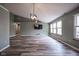 Open living room with vaulted ceilings, gray walls, and wood floors at 1163 Randall Way, Brownsburg, IN 46112
