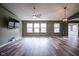 Open-concept living room features many windows and durable flooring at 1163 Randall Way, Brownsburg, IN 46112