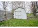 Backyard features a white storage shed with double doors, offering ample outdoor storage space at 1163 Randall Way, Brownsburg, IN 46112