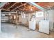 Unfinished basement with washer, dryer, exposed ceiling, and cement flooring at 12125 Broadway St, Indianapolis, IN 46236