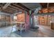 Unfinished basement with exposed ceiling, shelving, and cement flooring at 12125 Broadway St, Indianapolis, IN 46236