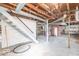 Unfinished basement with exposed ceiling, and stairs to the main level at 12125 Broadway St, Indianapolis, IN 46236