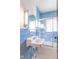 Bathroom with blue tiled walls, white fixtures, and a glass-enclosed shower at 12125 Broadway St, Indianapolis, IN 46236