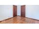 Bedroom with hardwood floors, two doors, and neutral-colored walls at 12125 Broadway St, Indianapolis, IN 46236