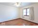 Bright bedroom with hardwood floors, ceiling fan, and window at 12125 Broadway St, Indianapolis, IN 46236