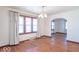 Dining room with hardwood floors, a chandelier, and natural light from the windows at 12125 Broadway St, Indianapolis, IN 46236