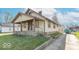 Street view of a quaint home with a covered porch and a side driveway at 12125 Broadway St, Indianapolis, IN 46236