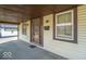 Covered front porch with a storm door and ample natural light at 12125 Broadway St, Indianapolis, IN 46236