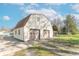 Exterior of barn-style home featuring a spacious two-car garage and a long driveway at 12125 Broadway St, Indianapolis, IN 46236
