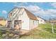 Exterior side view of barn-style home featuring a spacious two-car garage and a long driveway at 12125 Broadway St, Indianapolis, IN 46236