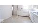 Galley kitchen featuring white cabinetry, a linoleum floor, and bright light at 12125 Broadway St, Indianapolis, IN 46236