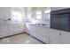 Kitchen features white cabinetry, linoleum flooring, and updated countertops at 12125 Broadway St, Indianapolis, IN 46236