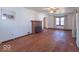 Cozy living room featuring a brick fireplace, hardwood floors, and ample space at 12125 Broadway St, Indianapolis, IN 46236