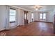 Bright living room with hardwood floors, multiple windows, and a ceiling fan at 12125 Broadway St, Indianapolis, IN 46236