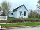Quaint single-Gathering home with a light blue exterior and a small, fenced-in front yard at 1237 N Sheffield Ave, Indianapolis, IN 46222