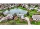 Stunning aerial view of luxury homes surrounding a serene lake in a well-manicured residential neighborhood at 12535 Glendurgan Dr, Carmel, IN 46032