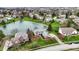 An aerial view captures upscale homes nestled around a beautiful lake in a lush, green residential area at 12535 Glendurgan Dr, Carmel, IN 46032