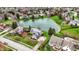 Aerial view of a home with pond frontage surrounded by well-manicured lawns at 12535 Glendurgan Dr, Carmel, IN 46032