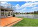Beautiful backyard view with deck overlooking a serene pond and green lawn at 12535 Glendurgan Dr, Carmel, IN 46032