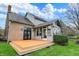 Expansive backyard view with sunroom, deck, and well-maintained lawn at 12535 Glendurgan Dr, Carmel, IN 46032