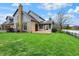 Landscaped backyard with a large pond, deck, and lush green lawn at 12535 Glendurgan Dr, Carmel, IN 46032