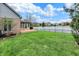 Green backyard featuring a pond, well-kept lawn, and privacy landscaping at 12535 Glendurgan Dr, Carmel, IN 46032