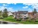 This angle shows a large lawn, patio, and walkout basement entrance, complemented by a well-maintained fence for privacy at 12535 Glendurgan Dr, Carmel, IN 46032