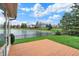 Picturesque backyard with deck offering tranquil pond views and lush landscaping at 12535 Glendurgan Dr, Carmel, IN 46032