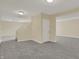 Unfinished basement featuring neutral paint, gray carpet and access to the staircase at 12535 Glendurgan Dr, Carmel, IN 46032