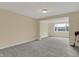 Unfinished basement featuring a large window, neutral paint and gray carpet at 12535 Glendurgan Dr, Carmel, IN 46032