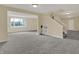 Unfinished basement featuring neutral paint, gray carpet and staircase to the main level at 12535 Glendurgan Dr, Carmel, IN 46032