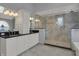 Bright bathroom features a large glass shower, double sink vanity with granite counters, and custom cabinetry at 12535 Glendurgan Dr, Carmel, IN 46032