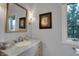 Elegant bathroom with a marble vanity and a decorative mirror at 12535 Glendurgan Dr, Carmel, IN 46032