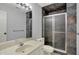 Bathroom featuring shower, stone walls, vanity with a white sink, and toilet at 12535 Glendurgan Dr, Carmel, IN 46032