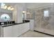 Bathroom features a large glass shower, double sink vanity with granite counters, and custom cabinetry at 12535 Glendurgan Dr, Carmel, IN 46032