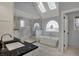 Bright bathroom boasts a soaking tub, glass shower, skylights, and decorative stained glass window at 12535 Glendurgan Dr, Carmel, IN 46032